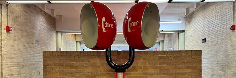 Photo of two red pay phones in one of the hallways.