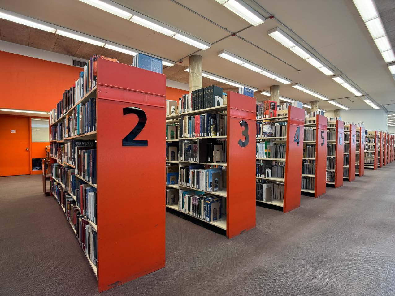 Photo of red numbered Library book shelves 