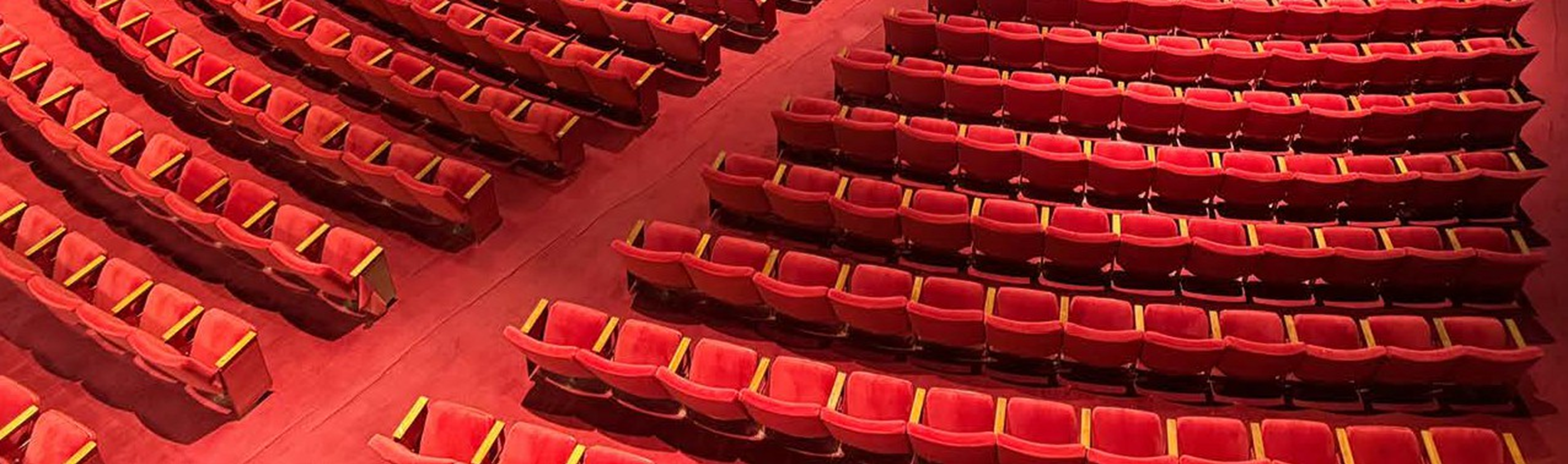 Photo of the red seats inside the Performing Arts Center auditorium.