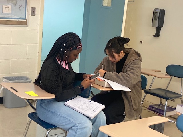 Two students in a classroom Two students in a classroom working at their desks
