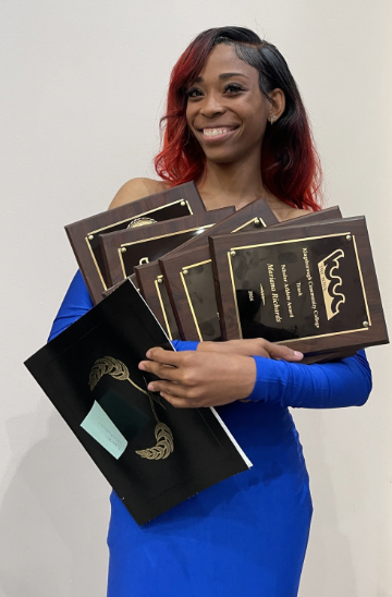 National track champion and women's basketball forward Mariana Richards has her hands full at the annual athletics banquet. Richards is one of the many student athletes helping to put Kingsborough's athletic program on the map.&nbsp;