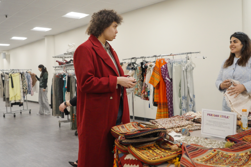 student and staff member in store